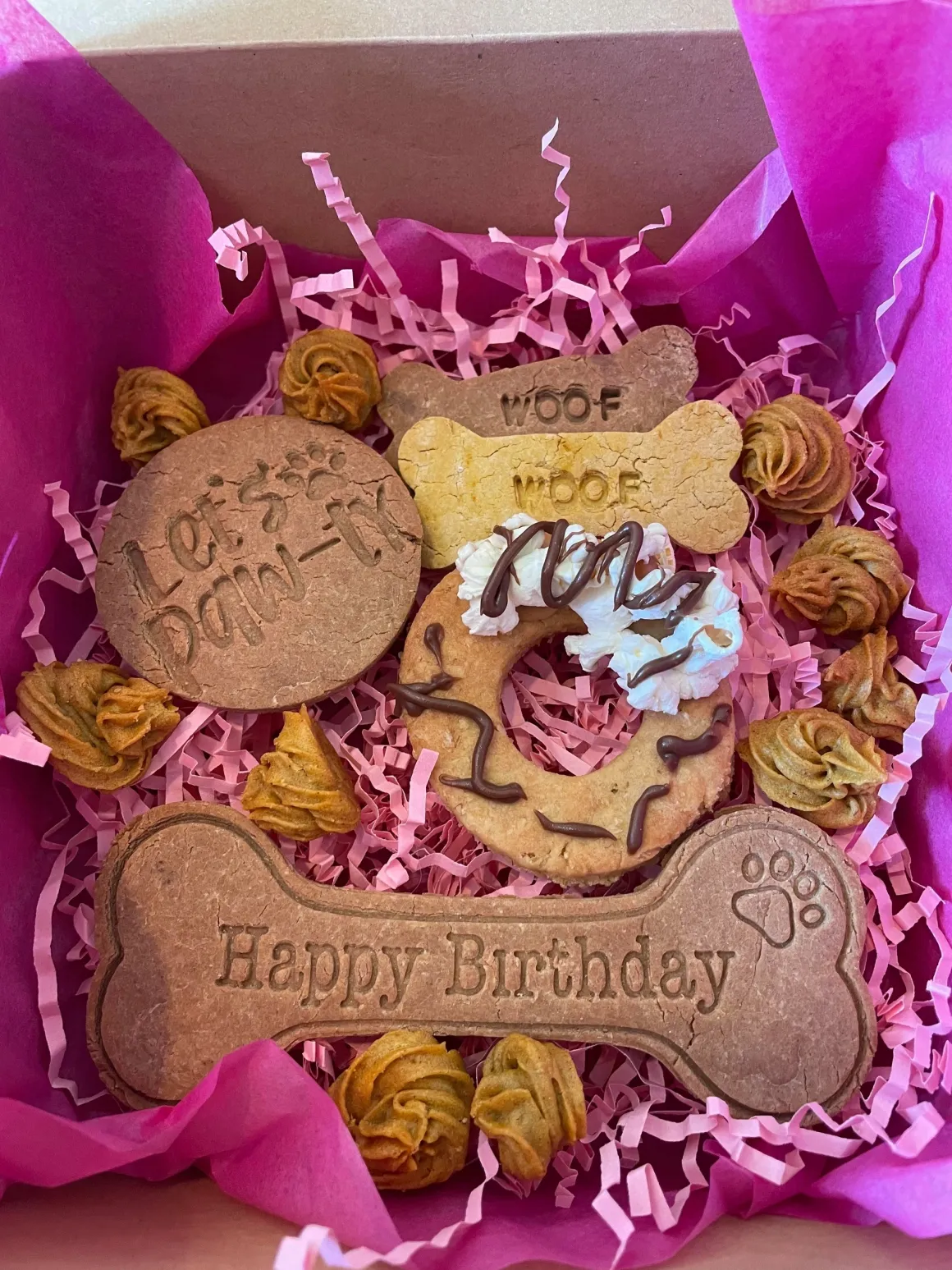 The Pawfect Barkery custom birthday box with Happy Birthday bone biscuit, Let's Paw-ty cookie, WOOF WOOF bones and popcorn donut